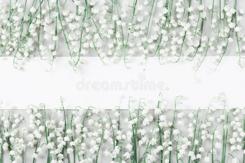 Wedding mockup with white paper blank and lily of the valley flowers on light table top view. Beautiful floral pattern. Flat lay. royalty free stock images Wedding mockup with white paper blank and lily of the valley flowers on light table top view. Beautiful floral pattern. Flat lay. royalty free stock images