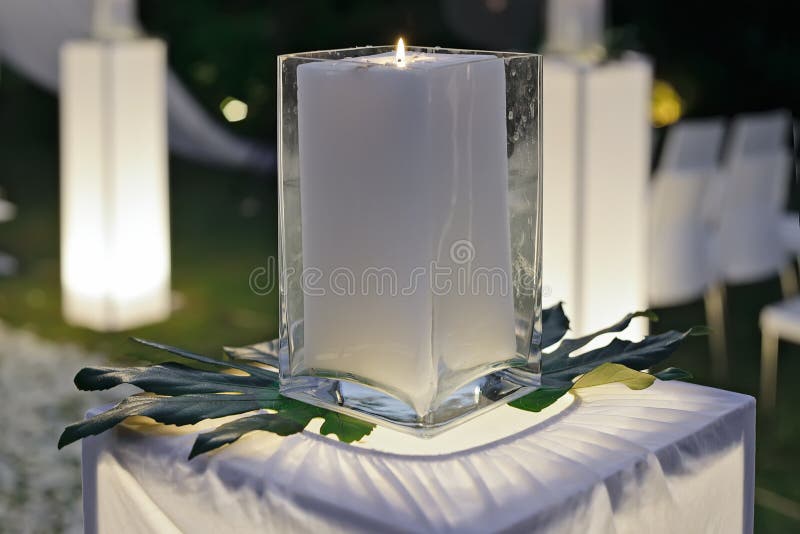 A wedding reception decorated with candles and plants