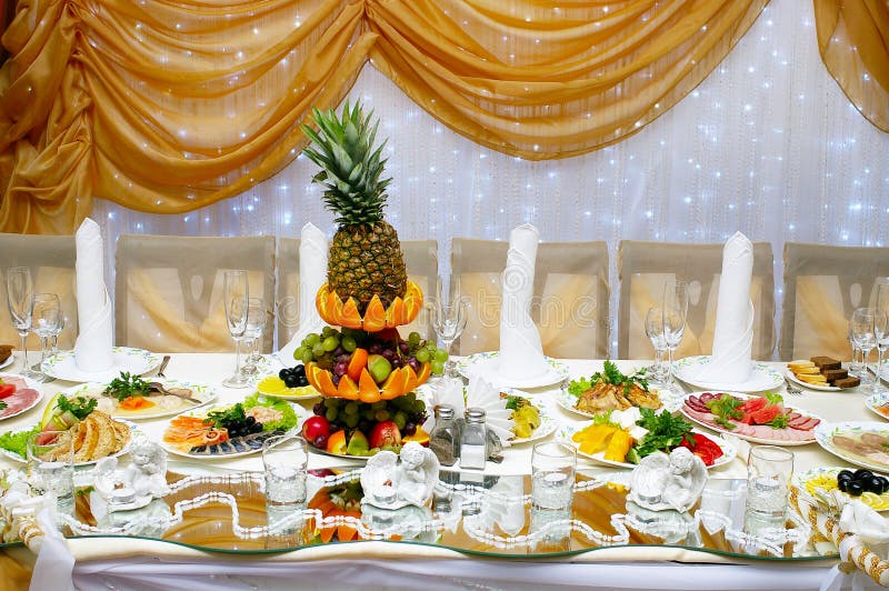 Table served with lots of food for wedding reception. Table served with lots of food for wedding reception