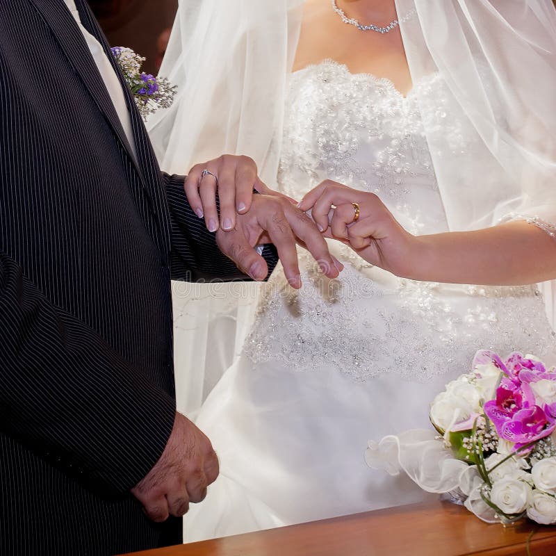 Bride And Groom Exchanging Wedding Rings, Putting On Fingers During