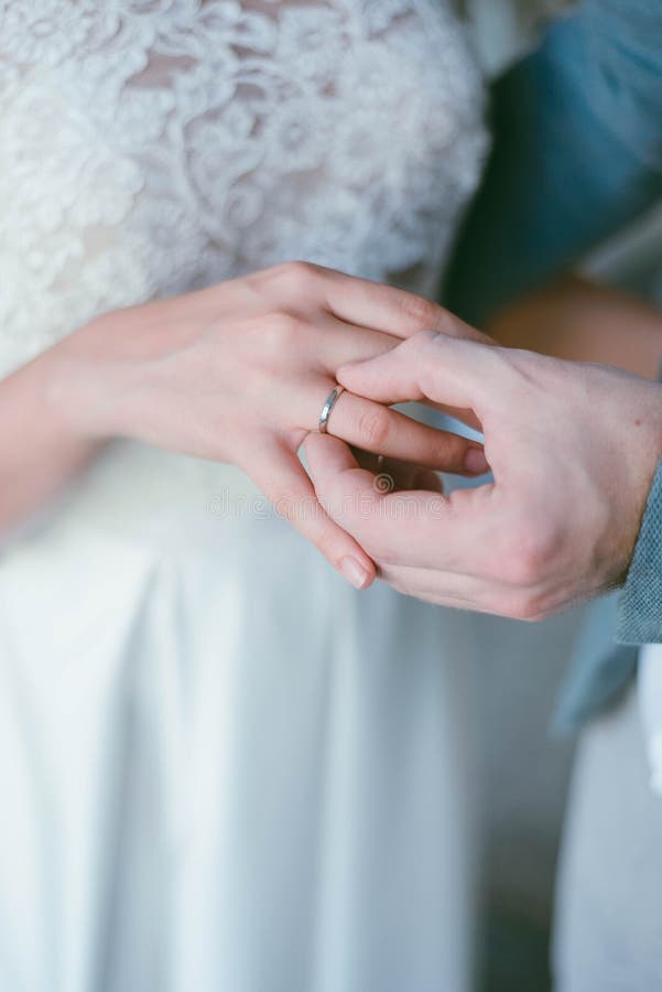 Wedding Ring on the Finger. the Groom Puts the Ring on the Bride Stock