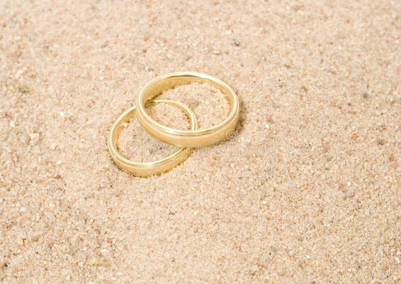 Wedding Rings for Couple Lover on the Sandy Beach. Engagement Rings in