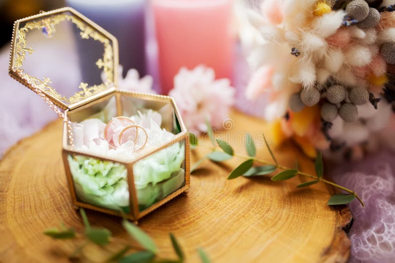 Wedding rings in jewelry box on a wooden texture surface stock photos Wedding rings in jewelry box on a wooden texture surface stock photos