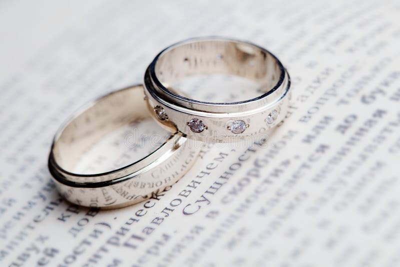 Wedding rings on the book stock image. Image of background 53017071