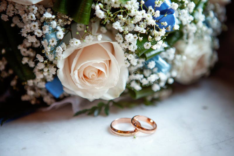 Wedding rings and bouquet stock photo. Image of background - 99244382