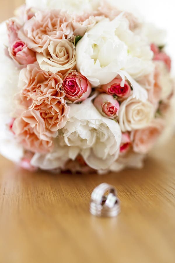 Wedding rings with bouquet stock image. Image of circle 45018225