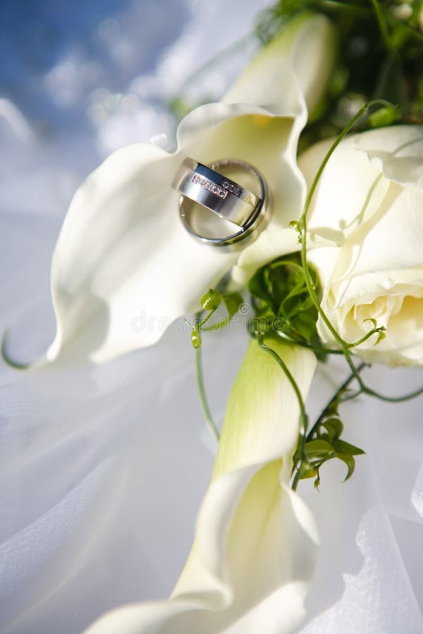 Wedding rings and flowers stock photo. Image of wedding 8606282
