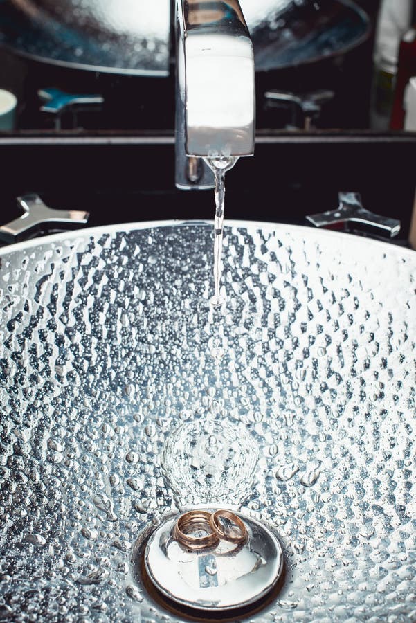 Wedding Rings in a Chromeplated Wash Basin. Reflections of Light
