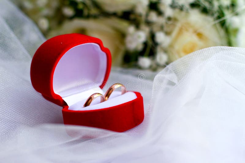 Wedding Rings in a Red Box and a Bouquet Close-up Stock Photo - Image ...