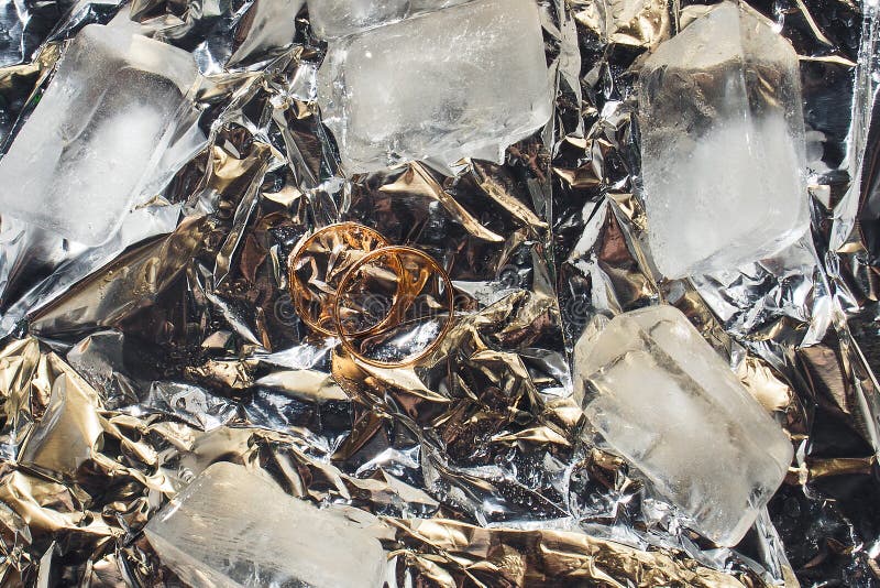 Wedding Rings with Splashes of Water and Pieces of Ice. Wedding Concept
