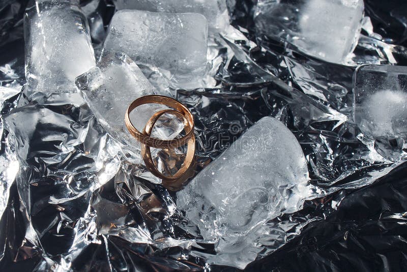 Wedding Rings with Splashes of Water and Pieces of Ice. Wedding Concept