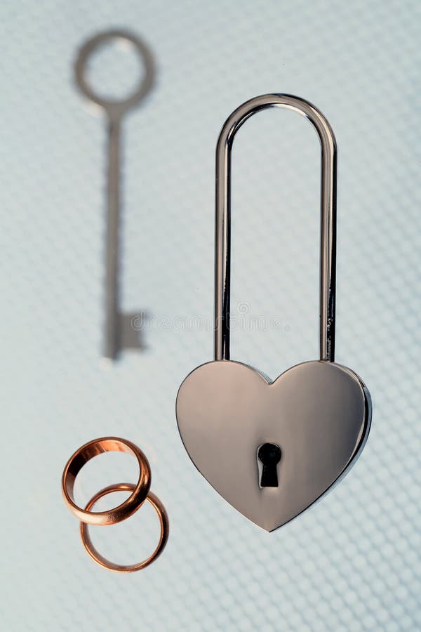 Wedding Rings, Steel Lock and Key on Light Background Stock Image