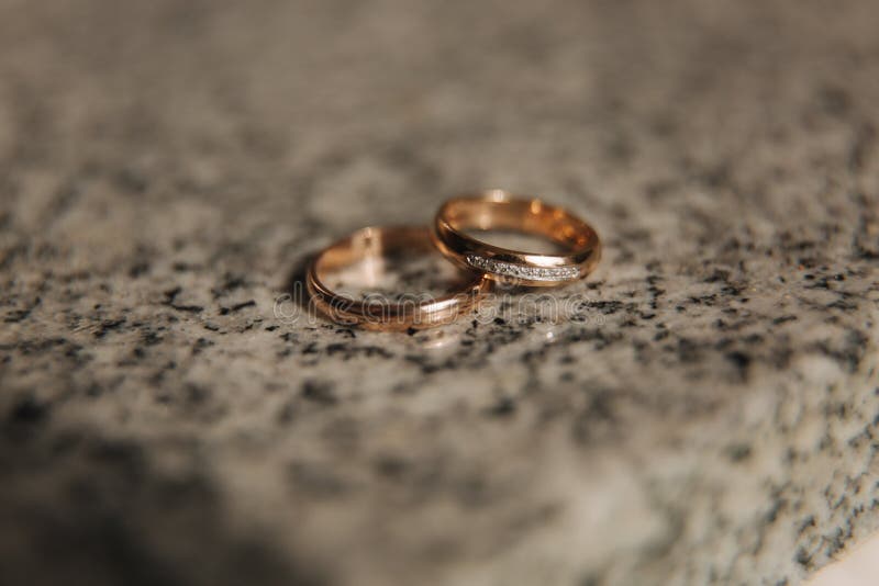 Wedding Rings on Table. Gold Rings with Diamond on Sun. Wedding