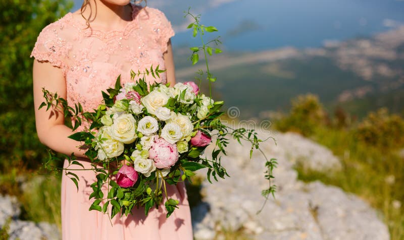 Wedding roses and peonies in the hands of the bride. Wedding