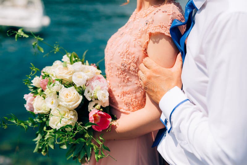 Wedding roses and peonies in the hands of the bride. Wedding in