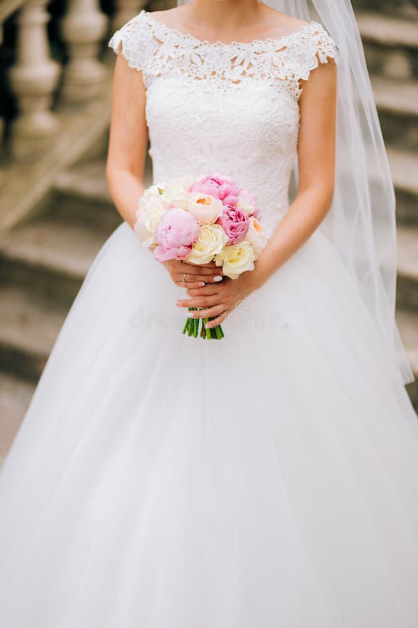 Wedding roses and peonies in the hands of the bride. Wedding in. Arrangement, bridal.