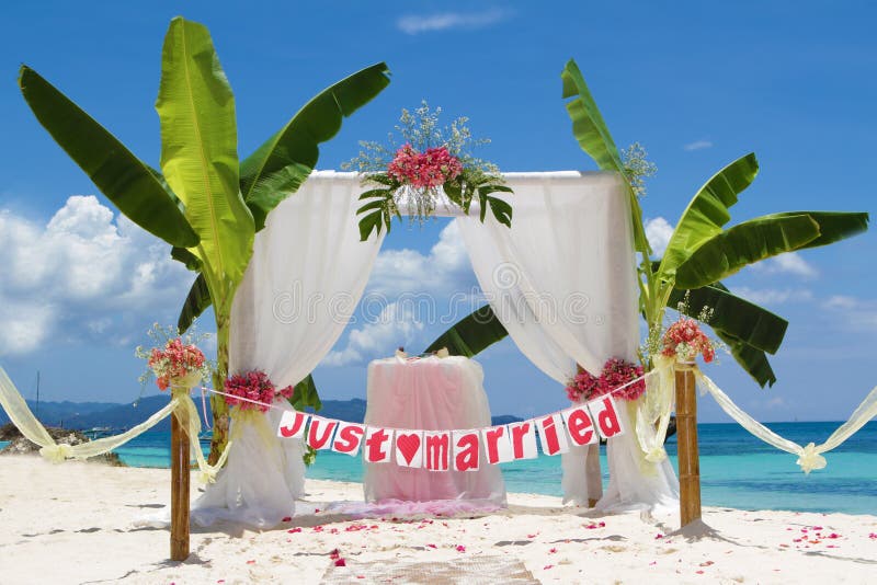 Wedding setup and flowers on tropical beach background