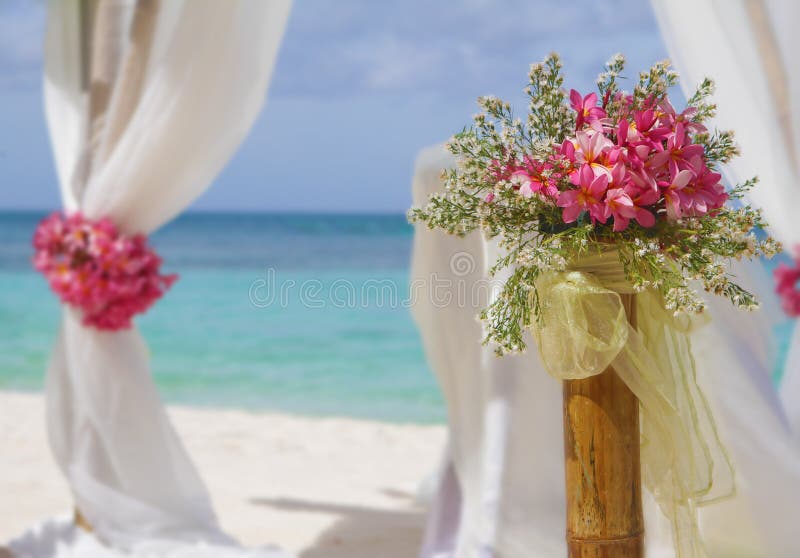 Wedding setup and flowers on tropical beach background