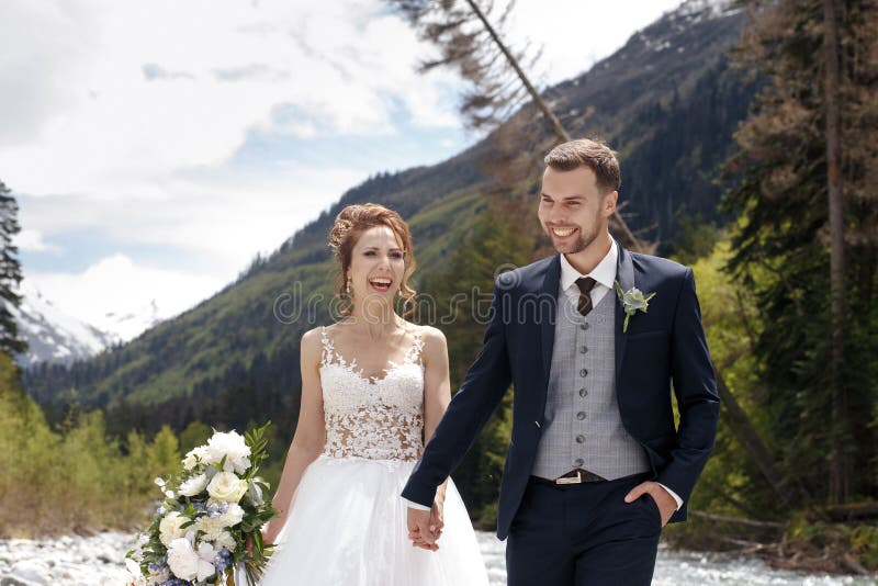Wedding Weg Die Braut und der Bräutigam gehen entlang die Flussbank und halten sich ` s Hände Portrait der Braut und des Bräutiga lizenzfreies stockfoto Wedding Weg Die Braut und der Bräutigam gehen entlang die Flussbank und halten sich ` s Hände Portrait der Braut und des Bräutiga lizenzfreies stockfoto