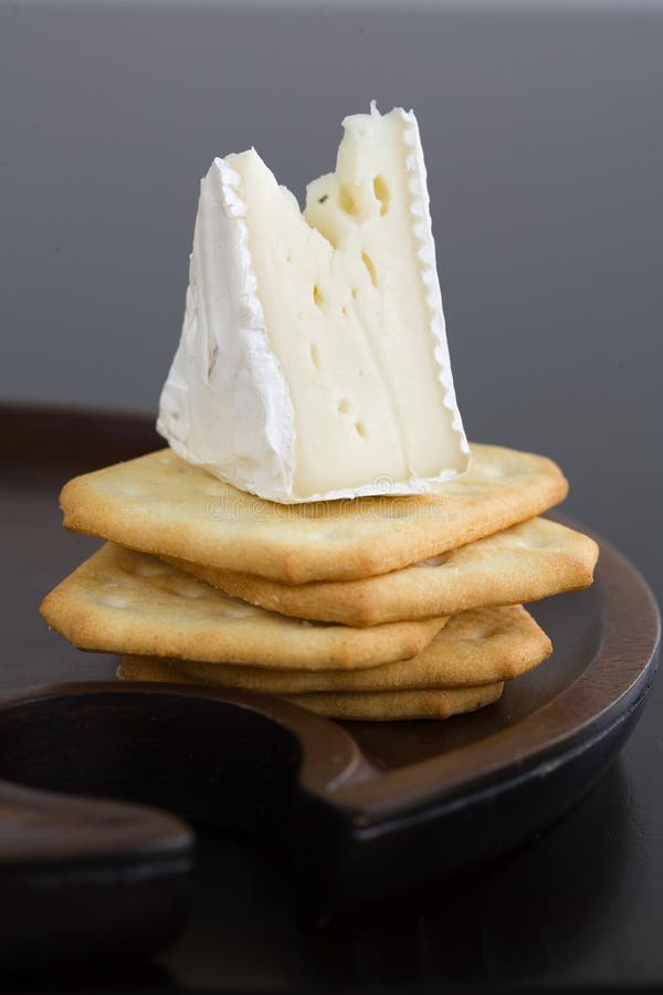 Wedge Of Brie Cheese On Butter Crackers Wedge Of Brie Cheese On Butter Crackers Stock Image