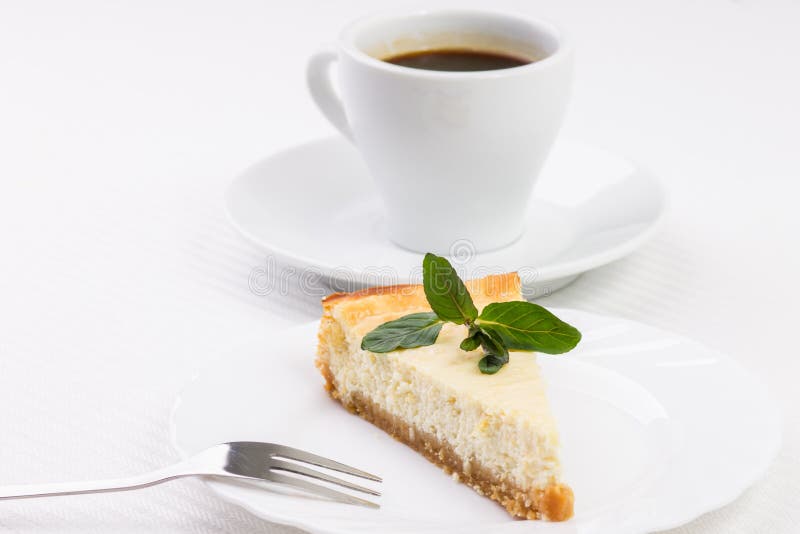 Wedge of cheesecake with leaves of mint