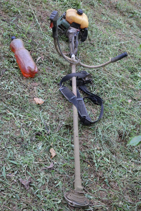 Weed Cutter Powered by Gasoline Kept in Ground after Work Stock Photo
