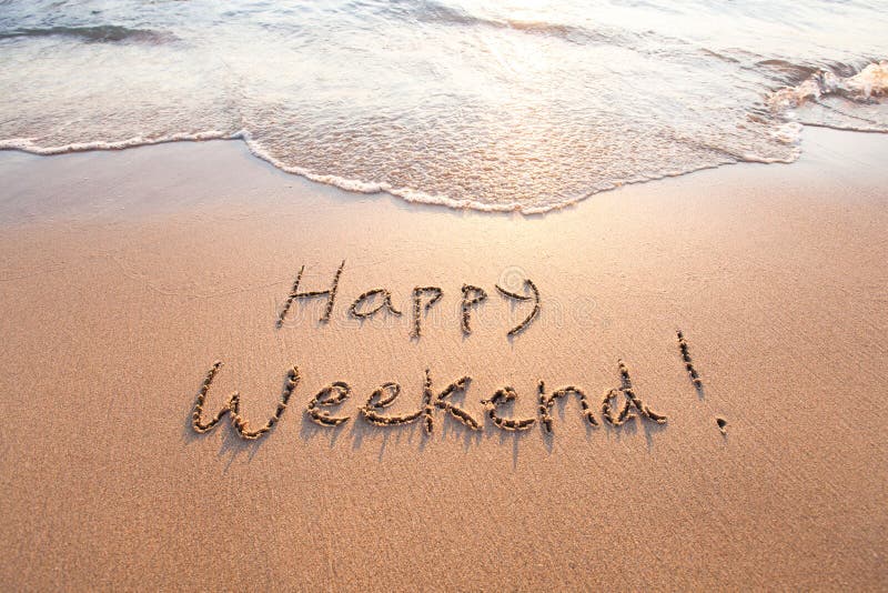 Happy weekend, greeting card written on sand. Happy weekend, greeting card written on sand