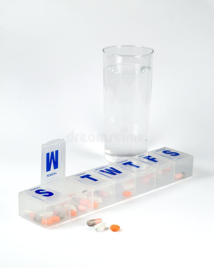 Weekly pill box with glass of water