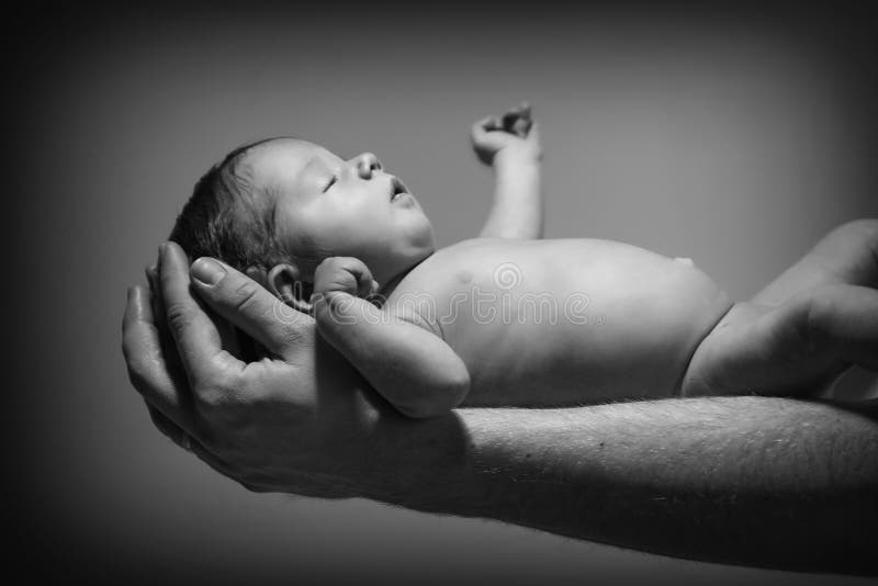 3 weeks old newborn girl on the hands of father