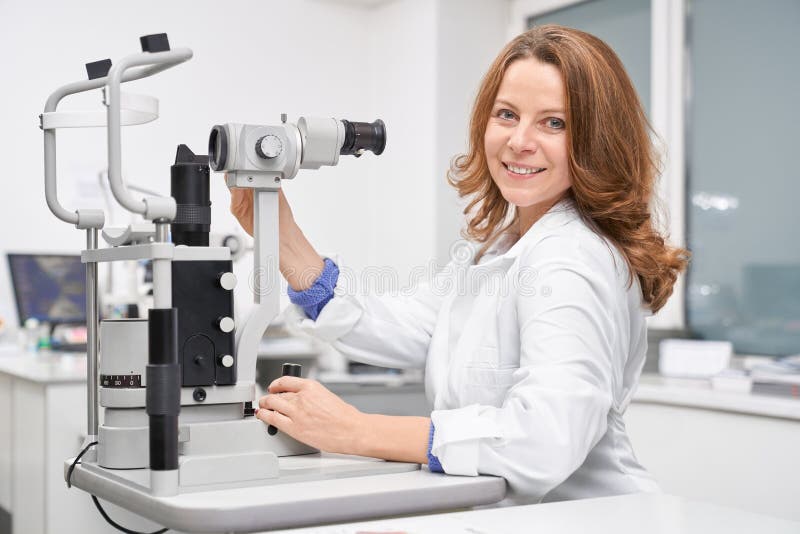 Weiblicher Augenarzt, der in der Klinik arbeitet und Sehvermögen überprüft stockfotos Weiblicher Augenarzt, der in der Klinik arbeitet und Sehvermögen überprüft stockfotos