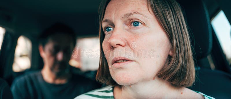 Female driver arguing with male passenger in a car, selective focus. Female driver arguing with male passenger in a car, selective focus