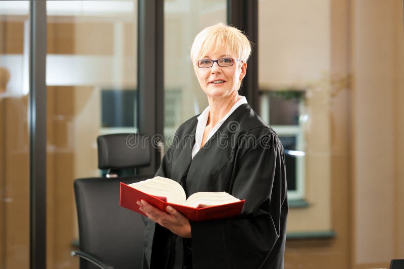 Female lawyer with German civil law code in a court room. Female lawyer with German civil law code in a court room