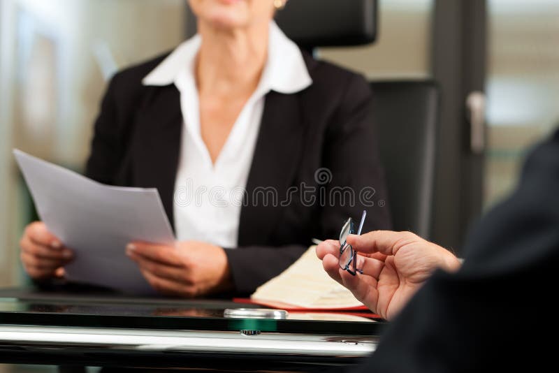 Mature female lawyer or notary with client in her office for counseling. Mature female lawyer or notary with client in her office for counseling