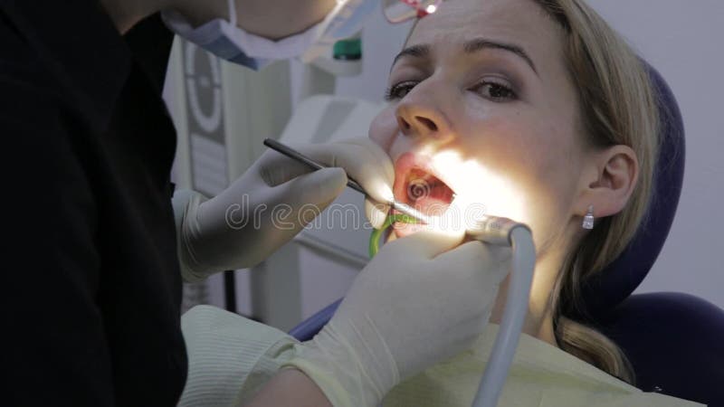 Weiblicher Zahnarzt behandelt einen Patienten in der zahnmedizinischen Klinik Zahn-und Kontrolle Stomatologist behandelt die Zähn