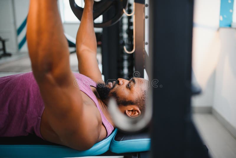 Weight Lifter at the Bench Press Lifting a Barbell on an Bench. Stock Photo Image of