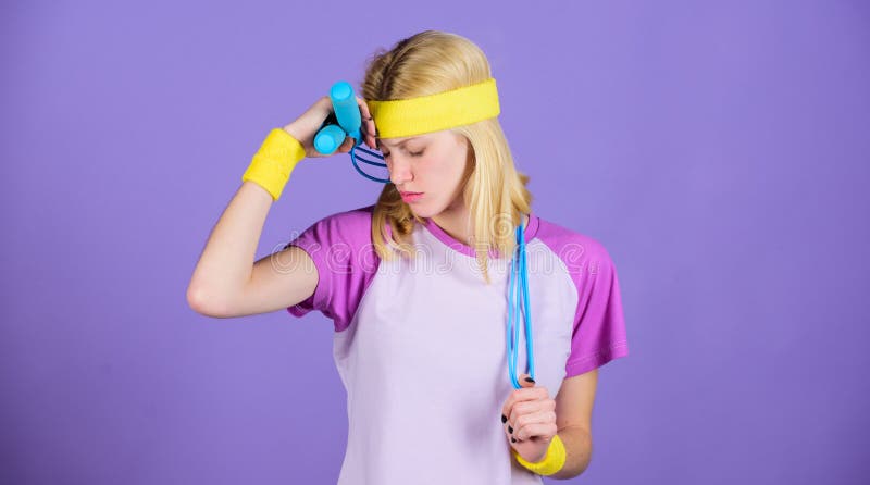 Weight loss concept. Jumping rope is great calorie burner. Girl hold jumping rope wear bright wristbands. Woman royalty free stock image Weight loss concept. Jumping rope is great calorie burner. Girl hold jumping rope wear bright wristbands. Woman royalty free stock image