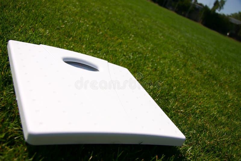 Weight scales on green grass outside. Weight watchers stock images, royalty-free photos and pictures