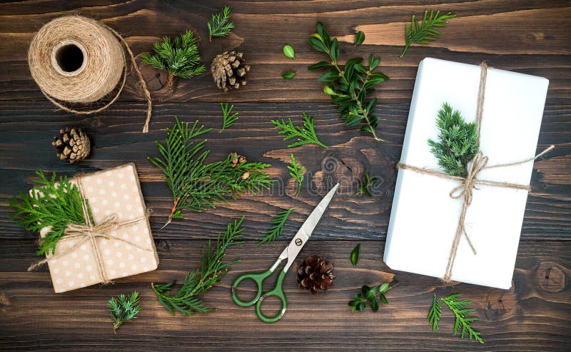 Christmas background with hand crafted gifts, presents on rustic wooden table. Christmas or New year DIY packing. Holiday decor concept. Overhead, flat lay, top view. Christmas background with hand crafted gifts, presents on rustic wooden table. Christmas or New year DIY packing. Holiday decor concept. Overhead, flat lay, top view