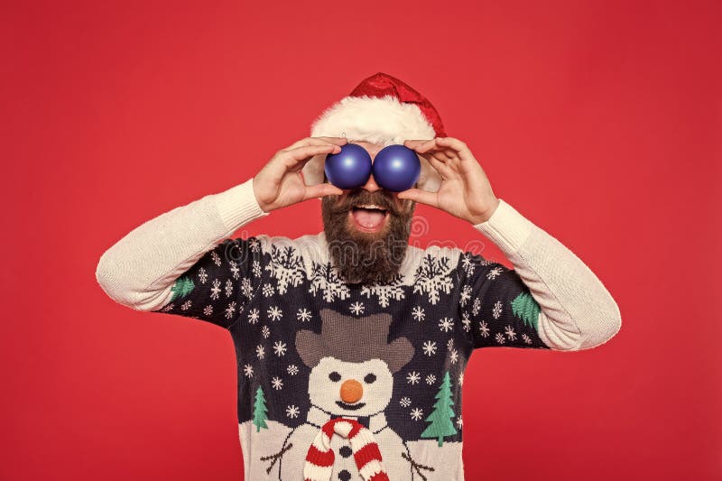 Weihnachtsmann in Hut und Weihnachtspulli halten Xmas Dekoration für Neujahrsferien isoliert auf rot stockfoto