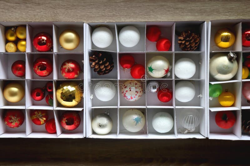 Boxes with various organized Christmas ornaments. Decorating or taking down the Christmas tree. Top view. Boxes with various organized Christmas ornaments. Decorating or taking down the Christmas tree. Top view.