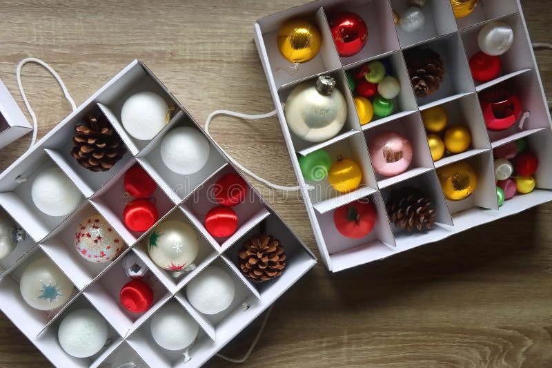 Boxes with various organized Christmas ornaments. Decorating or taking down the Christmas tree. Top view. Boxes with various organized Christmas ornaments. Decorating or taking down the Christmas tree. Top view.