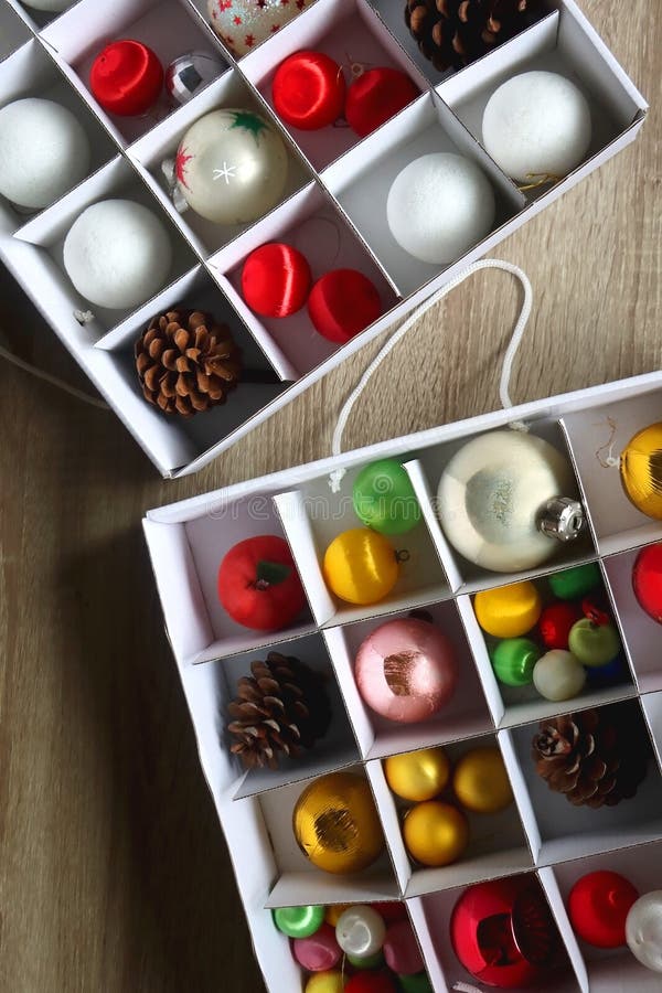 Boxes with various organized Christmas ornaments. Decorating or taking down the Christmas tree. Top view. Boxes with various organized Christmas ornaments. Decorating or taking down the Christmas tree. Top view.