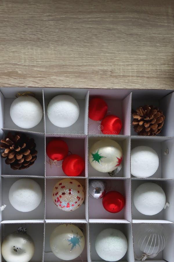 Boxes with various organized Christmas ornaments. Decorating or taking down the Christmas tree. Top view. Boxes with various organized Christmas ornaments. Decorating or taking down the Christmas tree. Top view.