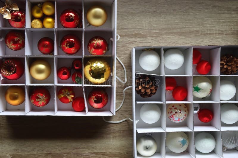 Boxes with various organized Christmas ornaments. Decorating or taking down the Christmas tree. Top view. Boxes with various organized Christmas ornaments. Decorating or taking down the Christmas tree. Top view.