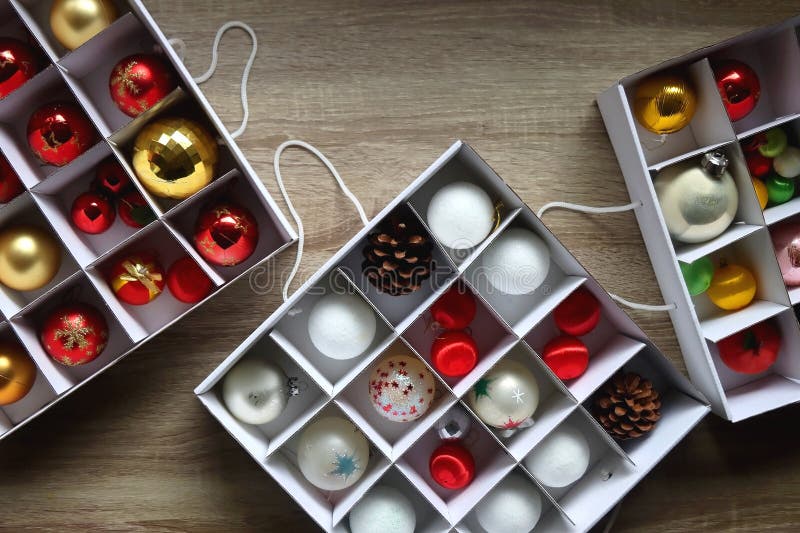 Boxes with various organized Christmas ornaments. Decorating or taking down the Christmas tree. Top view. Boxes with various organized Christmas ornaments. Decorating or taking down the Christmas tree. Top view.