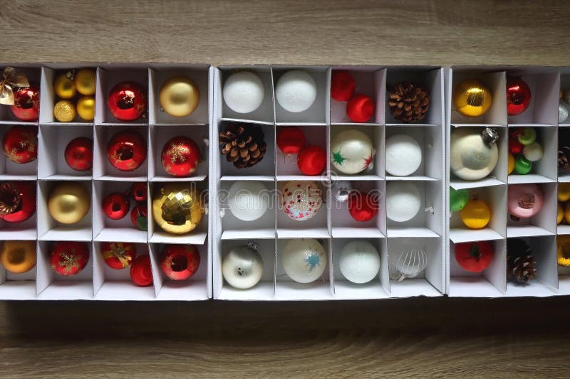 Boxes with various organized Christmas ornaments. Decorating or taking down the Christmas tree. Top view. Boxes with various organized Christmas ornaments. Decorating or taking down the Christmas tree. Top view.