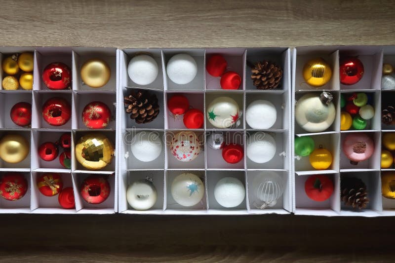 Boxes with various organized Christmas ornaments. Decorating or taking down the Christmas tree. Top view. Boxes with various organized Christmas ornaments. Decorating or taking down the Christmas tree. Top view.