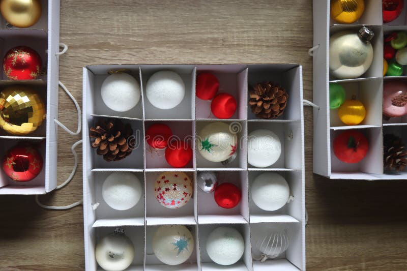 Boxes with various organized Christmas ornaments. Decorating or taking down the Christmas tree. Top view. Boxes with various organized Christmas ornaments. Decorating or taking down the Christmas tree. Top view.