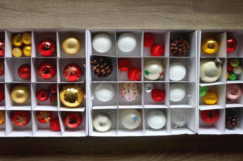 Boxes with various organized Christmas ornaments. Decorating or taking down the Christmas tree. Top view. Boxes with various organized Christmas ornaments. Decorating or taking down the Christmas tree. Top view.