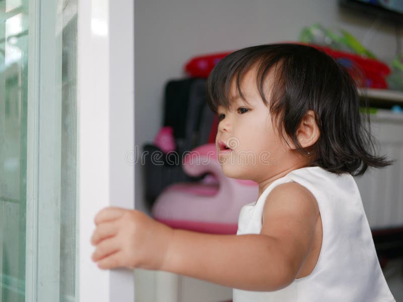 Weinig Aziatisch babymeisje/dichte schuifdeur die leren zelf te sluiten stock fotografie Weinig Aziatisch babymeisje/dichte schuifdeur die leren zelf te sluiten stock fotografie